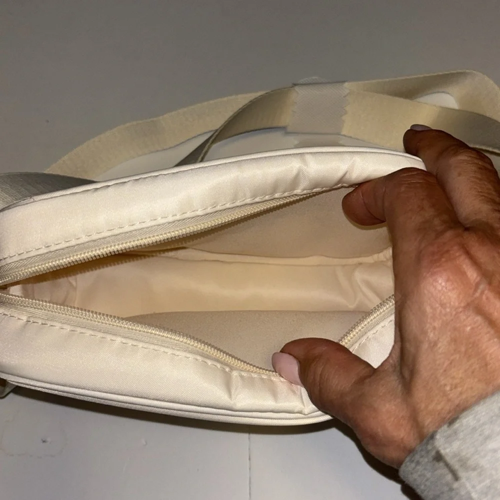 BIOSSANCE…CREAM COLORED CROSSBODY…ADJUSTABLE STRAP EXCELLENT CONDITION LOOKS NEW